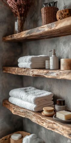 towels and soaps on wooden shelves in a bathroom