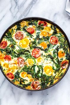 an egg and spinach casserole in a pan on a marble countertop