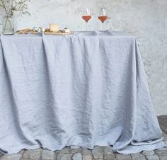 two wine glasses sitting on top of a table