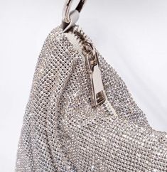 Turn heads with this must have beautiful rhinestone clutch purse. Elevate your style with dazzling glamour. Featuring a knotted top handle, slouchy pouch. This luxe bag is sure to complete your occasion look. Silver-tone mesh Clear rhinestone embellishments Rhinestone Purse Size: Length 13.3 inches, Width 0.3 inches, Height 6.2 inches All accessories are FINAL SALE PCC-AIL-N/A Chic Evening Bag With Bling For Night Out, Chic Bling Shoulder Bag, Chic Bling Clutch Evening Bag, Glamorous Evening Bag With Rhinestone Fringe, Rhinestone Purse, Rhinestone Handbags, Knotted Top, Rhinestone Clutch, Wedding Purse