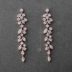 two pairs of earrings with diamonds on them