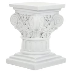 a white pedestal with an ornate design on the top and base, against a white background