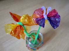 two colorful lollipops in a small glass jar