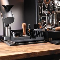 an espresso machine sitting on top of a wooden table