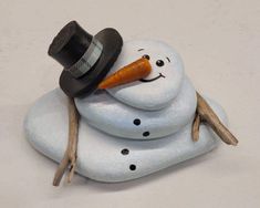 a snowman with a carrot in his mouth and a hat on it's head