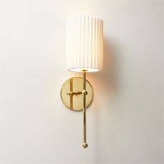 a wall light with a white shade on it's side and a gold arm