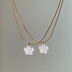 Pearlescent dainty white shell carved into a lovely flower, strung on a 18k gold stainless steel snake chain. This necklace is waterproof and anti-tarnish. Find the bigger shell flower necklace here https://novemberjewelsco.etsy.com/listing/1759992322 ♡MATERIAL♡ Genuine seashell pendant, chain is 18k gold PVD coating on stainless steel, this necklace is anti-tarnish and waterproof, you can wear it 24/7. ♡CHAIN LENGTH♡ 16" snake chain + 2" extender Model is wearing 16" in the pictures ♡PENDANT ME White Flower Pendant Charm Necklace With Delicate Chain, Adjustable Dainty Mother Of Pearl Jewelry, White Adjustable Charm Necklace With Flower Charm, Delicate Handmade White Charm Necklaces, White Adjustable Flower Charm Necklace, Handmade White 14k Gold-filled Necklaces, Handmade White 14k Gold Filled Necklaces, White Dainty Flower Charm Necklaces, Dainty Flower Shaped Pearl Charm Jewelry