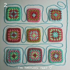 crocheted squares are arranged on a white surface