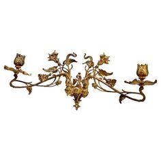 an ornate gold chandelier with flowers and leaves