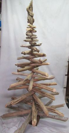 a wooden christmas tree made out of driftwood