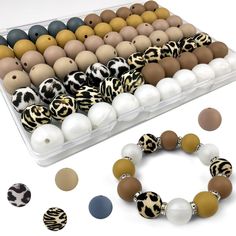 an assortment of different colored beads in a plastic container