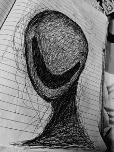 a drawing of a person's head on top of a piece of paper