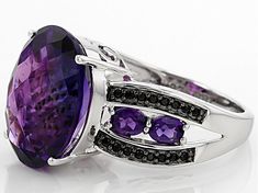 Pre-Owned 7.13ct oval Moroccan amethyst with .51ctw oval African amethyst and .13ctw round black spinel sterling silver ring. Measures approximately 5/8"L x 1/16"W. Not sizeable. Rhodium plated. Black rhodium..  This product may be a customer return, vendor sample, or on-air display and is not in its originally manufactured condition.  It may not be new.  In some instances, these items are repackaged by JTV. Purple Oval Stone Jewelry, Purple Oval Stones Jewelry, Purple Oval Jewelry With Stones, Oval Amethyst Gemstones With Accents, Oval Amethyst Gemstones With Gemstone Accents, Oval Purple Jewelry With Gemstone Accents, Purple Oval Jewelry With Gemstone Accents, Oval Purple Gemstones With Accent Stones, Purple Oval Gemstones With Accent Stones