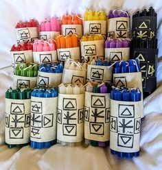 many different colored crayons sitting on top of each other