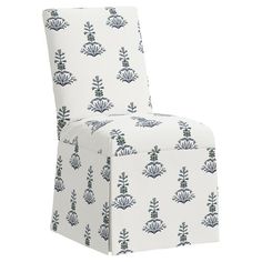 an upholstered chair with blue and white designs on the back, sitting in front of a white background