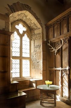 a room with wood paneling and stained glass windows