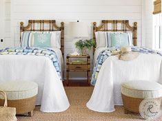 two beds in a room with white walls and wood trimmings on the headboards