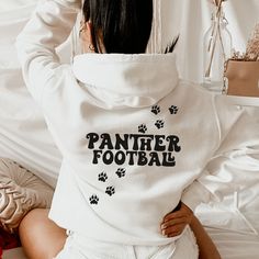 Show your panther spirit with this warm and cozy hoodie!  Panther Football! This panthers pullover is great for all the all the seasons! This unique design is perfect on the popular Gildan brand hoodie. This hoodie will keep you warm throughout the fall and winter!  A pre-shrunk, classic fit hoodie that's made with air-jet spun yarn for a soft feel and reduced pilling. ** P R O D U C T **  - 50% cotton, 50% polyester  - Pre-shrunk  - Classic fit  - Direct to Garment print (no stencils or vinyl which means it will last a lot longer)   - Printed and Shipped in the USA  - Due to different monitor screens colors may vary ** S I Z I N G **  - Consult size chart in listings for measurements  - Sizing is Unisex for all hoodie, runs true to size  - For an oversized fit, select 1 to 2 sizes up from Panther Spirit, Panther Football, Cheer Gear, Panther Nation, School Spirit Wear, Panthers Football, School Spirit Shirts, Cute Shirt Designs, Mom Hoodies