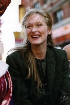 a woman sitting on the ground with her eyes closed