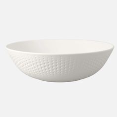 a white bowl with holes in it