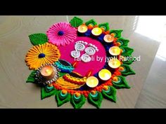 a decorated diya with candles and flowers