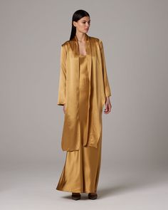 The versatile Featherlight Wrap Blouse features long front sashes that can be worn loosely or tied for a sophisticated lightweight blouse. The luminous silk charmeuse fabric is drapey and soft to the touch. 100 % Silk Charmeuse Made in New York City Dry Clean Only Sheila Hicks, Charmeuse Fabric, Gold Blouse, Caftan Dress, Silk Tank, Silk Charmeuse, Bell Sleeve Dress, Wrap Blouse, Ethical Fashion