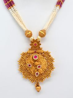 This beautiful antique gold pendant features Kemp stones and American diamonds, paired with a Pearl Mala Necklace and earrings set. This exquisite necklace enhances your style for any occasion, adding sparkle whether you wear it with a dress or a stunning saree. Necklace Length: 11.5" and can be adjusted with a chain. Earring length: 1.5" with push-back closure Antique gold Polish and High-quality brass as the base metal Availability: In-Stock. *Color may vary slightly due to light condition & p 22k Gold Pearl Necklace For Celebrations And Festivals, Ornate Chandbali Kundan Necklace For Festive Occasions, Temple Jewelry Style Necklace With Tilla For Anniversary, Festive Yellow Gold Kundan Pendant Necklace, Ornate Kundan Necklace For Diwali Festivities, Festive Temple Jewelry With Pearl Pendant, Festive 22k Gold Pearl Pendant Jewelry, Festive Kundan Pendant Necklace With Latkans, Gold Temple Necklace With Pearl Pendant