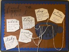 a bulletin board that has some writing on it with notes attached to the board and string