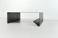 a black table sitting on top of a white floor