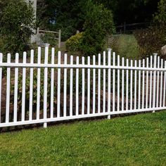 a white picket fence in the grass