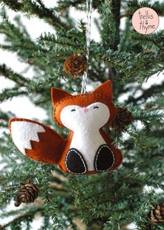 an ornament hanging from a tree with a fox on it's head