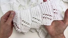 two hands holding white crocheted cloths on top of each other