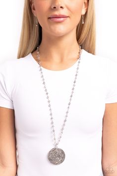 Stamped in a floral motif, an oversized silver medallion blooms from the bottom of an extended silver chain adorned with silver pearls and smoky crystal-like beads for a whimsical flair. Features an adjustable clasp closure. Sold as one individual necklace. Includes one pair of matching earrings. Gray Pearl Jewelry For Party, Elegant Silver Crystal Necklace With Pearl Chain, Silver Metal Pearl Necklace With Beaded Chain, Silver Necklace With Pearl Charm For Party, Silver Beaded Necklace With Pearl Chain, Silver Beaded Dangle Crystal Necklaces, Silver Dangle Beaded Crystal Necklaces, Adjustable Silver Pearl Necklace With Beaded Chain, Silver Crystal Beaded Necklace With Pearl Chain