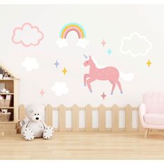 a child's room with a pink chair and wall decals on the walls