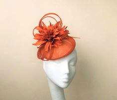 This modern orange looped headpiece with its  burst of tonal orange flower makes a great addition to any wedding or race day outfit.  Colour can be matched for your requirements.  Handmade using the highest quality materials.  The disc is approx 16cm in diam Secured with elastic or satin hairband in a choice of colours to blend your hair colour. Each piece is handmade by me, for you, using the highest quality materials which takes about 5 days. If you have a specific date you need the headpiece please get in touch and I will ensure you receive in good time. If you would like the piece to be made to match your outfit, or adapted please contact me (a swatch can be sent or matched to your required colour) Presented in a branded hat box.  Please check policies and FAQ, as I cannot accept retur Wedding Guest Hat, Orange Fascinators, Yellow Fascinator, Wedding Hats For Guests, Fascinator Wedding, Orange Hat, Race Day Outfits, Black Fascinator, Ascot Hats