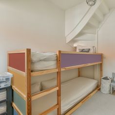 a bunk bed in a room with white walls