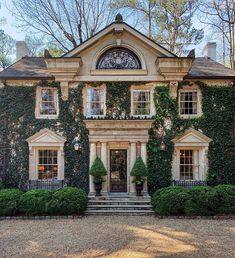 a large house covered in ivy and plants