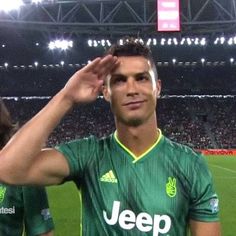 a soccer player saluting the crowd at a game