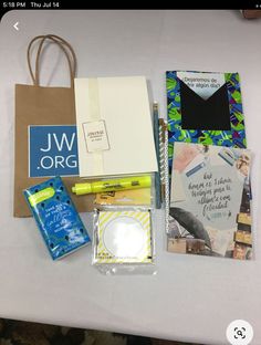 various items are laid out on a table to be used as an office supply bag