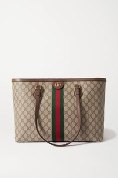 Combining three of Gucci's unmistakable signatures - the interlocking 'G's, the 'Supreme' motif and the striped webbing - this 'Ophidia' tote is perfect for fans of the label's maximalist approach. It's made from durable coated-canvas with sturdy leather trims and a single zipped pocket inside. The interior is roomy enough for the busiest day.Wear it with: [Khaite Sweater id1252860], [Prada Pants id1277464]. Khaite Sweater, Gucci Bags Handbags, Prada Pants, Hang Bag, Coach Floral, Gucci Tote Bag, 35th Birthday, Birthday Trip, Gucci Ophidia