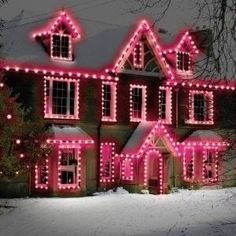 a large house covered in pink christmas lights