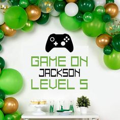 a video game console surrounded by balloons and streamers with the words game on jackson level 5