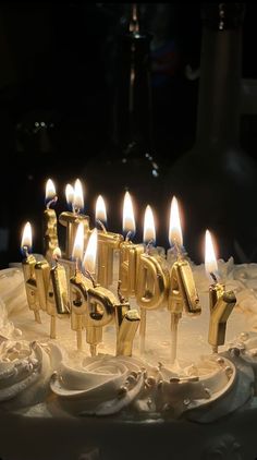 a birthday cake with lit candles on it