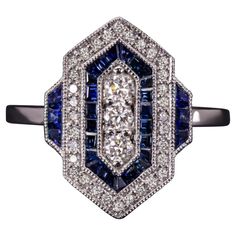 The chic geometric design glitters with vibrant diamonds and is punctuated by rich blue lines of meticulously custom cut sapphires. The effect is striking, gorgeously sophisticated, and eternally stylish! Whether you are buying for yourself or a special someone, this beauty is sure to delight! The diamonds are brilliantly white, graded G-H for color. Graded Si1 for clarity, they are all completely eye clean and stunningly vibrant. The natural sapphires are a rich, well-saturated blue that contrasts strikingly with the bright white of the diamonds and the 14k white gold. The sapphires are cut and set with exceptional craftsmanship. Each sapphire is individually cut to fit in the channel with zero gaps. This is a highly skilled and labor intensive process that truly making this ring a work o Blue Sapphire Diamond Ring, Saturated Blue, Blue Lines, Blue Sapphire Diamond, Sapphire Diamond Ring, Estilo Art Deco, Diamond Fashion, Natural Sapphire, Blue Line