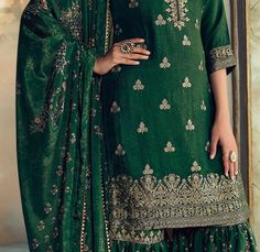 COLOR : Pine Green FABRIC : Top - Pure Dola Silk Jacquard, Bottom - Soft Crepe , Dupatta - Chinon Silk WORK : Woven Zari Work, Zari Embroidery, Digital Print, Hand Work, Beads, Stones, Sequins, Lace Border OCCASION : Wedding, Reception, Engagement, Party Wear READY-TO-WEAR : NoSTITCHING : Available as semi-stitched fabric, can be stitched using standard size option (+$20). Note: There might be a slight color variation due to lighting and flash used during photoshoot. The bright shade seen is the Wedding Gharara, Gharara Suits, Zari Embroidery, Holiday Promotions, Zari Work, Silk Wedding, Pine Green, Lace Border, Hand Work