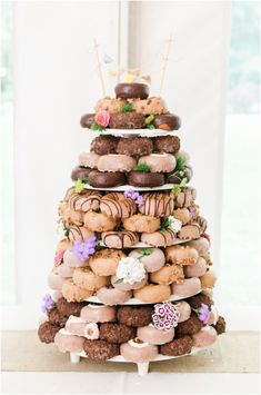 a tower of doughnuts on a table in the shape of a christmas tree