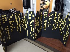 two pieces of cardboard with yellow and black squares on them sitting in front of a door