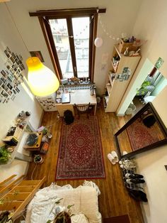 an overhead view of a living room with wood floors and lots of clutter on the floor