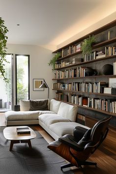 a living room filled with furniture and bookshelves