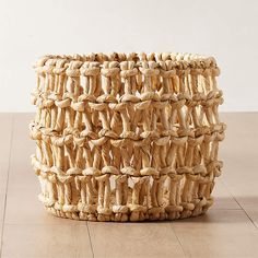 a woven basket sitting on top of a wooden floor